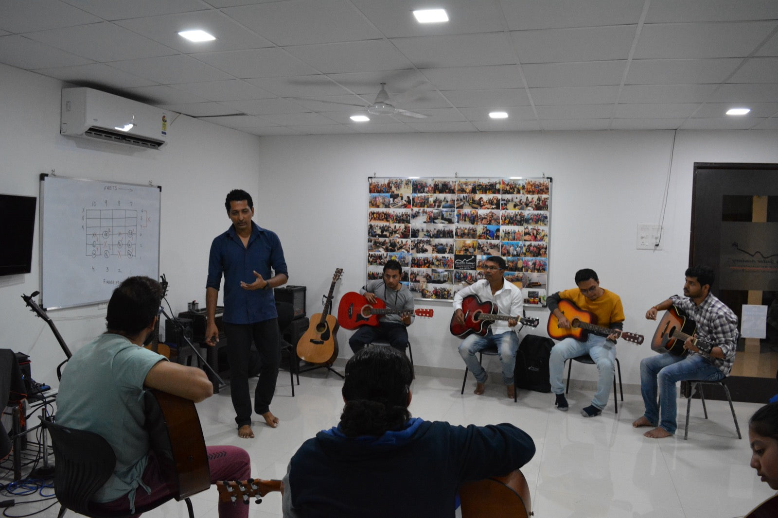 Instructor teaching a guitar class